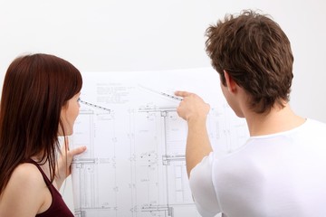 young couple with construction plan