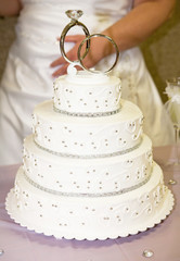 Pretty Wedding Cake With Rings on Top