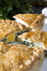 fresh home made spinach and artichoke  pie on a plate