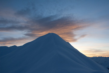 Fototapeta na wymiar blue mountain under orange cloud