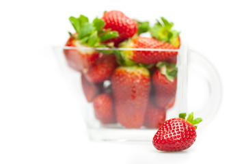 juicy strawberries in a bowl isolated on white