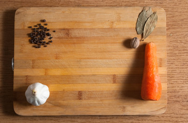 Cutting board with сarrot and garlic