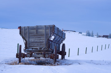Old Antique Wagon in snow covered field