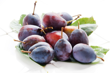 Plums on a white background.