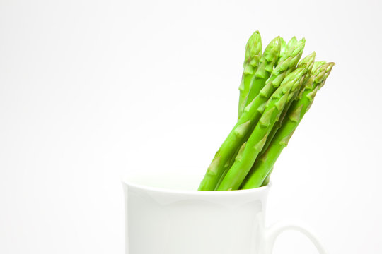 Fresh asparagus in the white cup - Powered by Adobe
