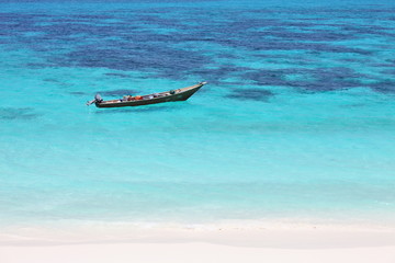 Lonely boat in turquoise sea