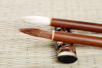 two asian calligraphy brushes