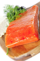 pink salmon on wooden plate with cheese