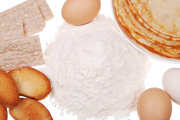 Pancake on a dish, flour, and eggs