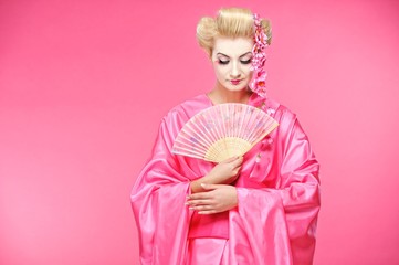 Beautiful geisha with a fan