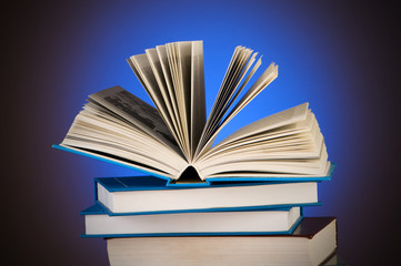 Stack of books against gradient background