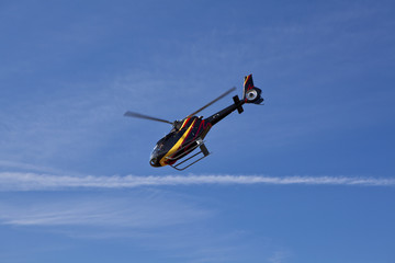 Fototapeta na wymiar Helicopter flying, blue sky