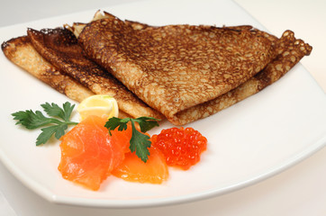 Salmon fish and caviar with russian pancakes