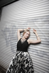 Woman with arms above her head