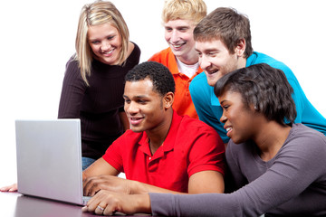 Multi-racial college students sitting around a computer