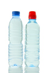Bottles  of mineral water reflected on white background