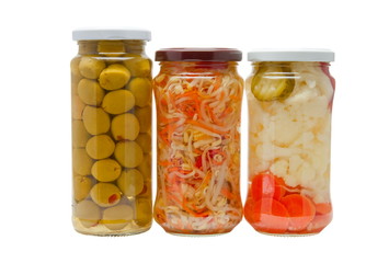 Glass jars with marinated vegetables  isolated on the white back
