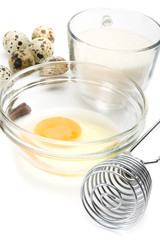 Dish of liquid egg, sugar, whisk and quail eggs
