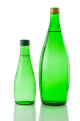 Bottles  of mineral water reflected on white background