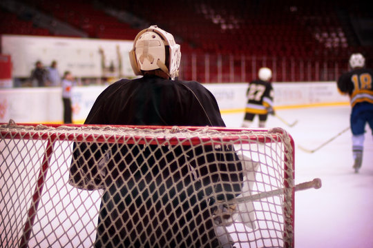 Hockey goalkeeper in generic black equipment