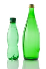 Bottles  of mineral water reflected on white background
