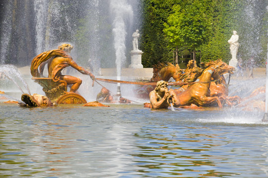 Apollo's fountain spraying water in Versailles Chateau.
