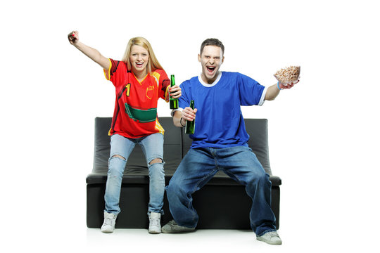 Excited man and woman watching sport isolated on white