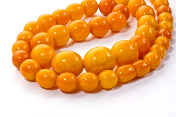 Amber chaplet lying on a white surface