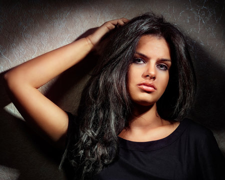Portrait of a beautiful young woman with dark hairs