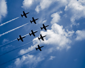 Seven jet airplanes with white smocks in formation - 21925315