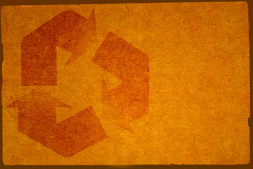 Cardboard Background with Worn Recycle Symbol