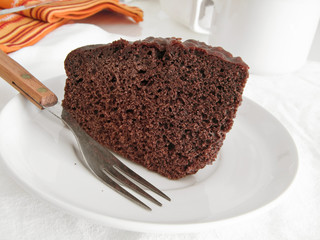 Chocolate Cake Slice on white dish.