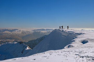 Fototapeta na wymiar Mountaineers on snowy summit