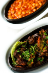 Kebap and Dry Beans in Black and White Dishes