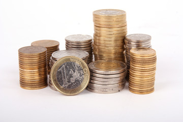 Piles of coins isolated on white background