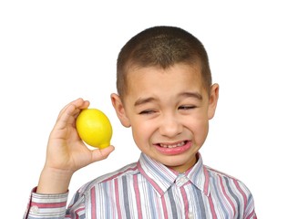 Boy holding a lemon , making a funny face