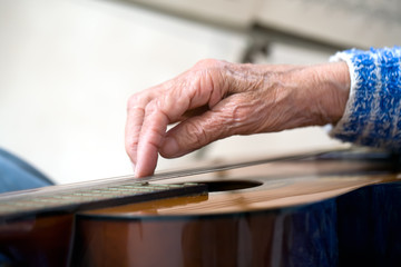 Old hands on guitar