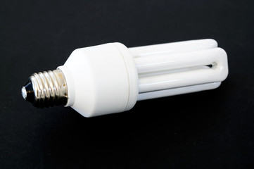 light bulb on dark black backdrop with copy space