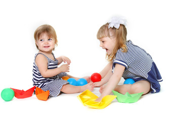 two cute young sisters playing over white