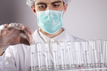 Scientist in laboratory examinates samples and chemical