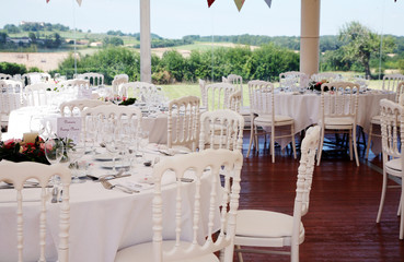 Table settings under a wedding marquee