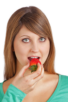 young lady eating a strawberry
