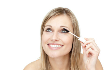 Jolly woman putting mascara