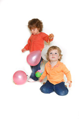 Fototapeta na wymiar two toddler girls with colorful balloons