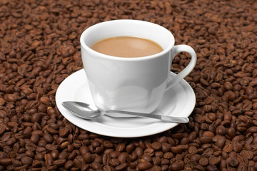Fototapeta premium Cup with coffee, costing on coffee grain