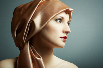 Portrait of the young girl with golden scarf on head