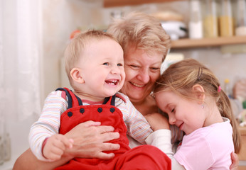 Cute little boy and little girl happy with grandmother