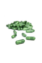 Green pills on a white background