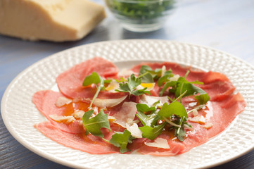 carpaccio with parmesan cheese and rucola
