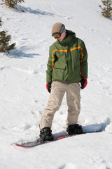 Fototapeta na wymiar Young man with snowboard